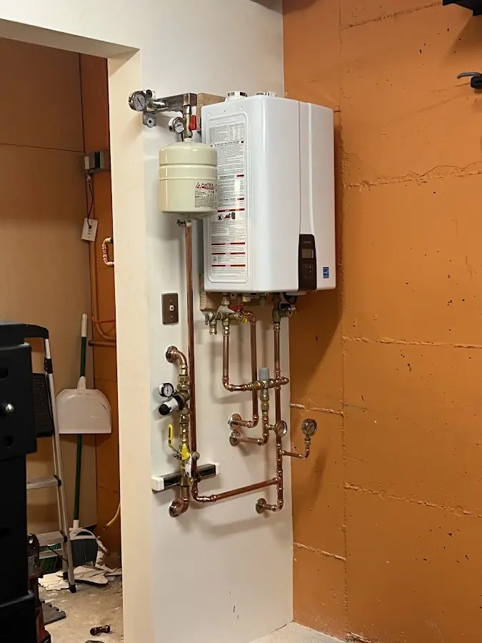 Plumbing technician inspecting water heater connections in Encinitas
